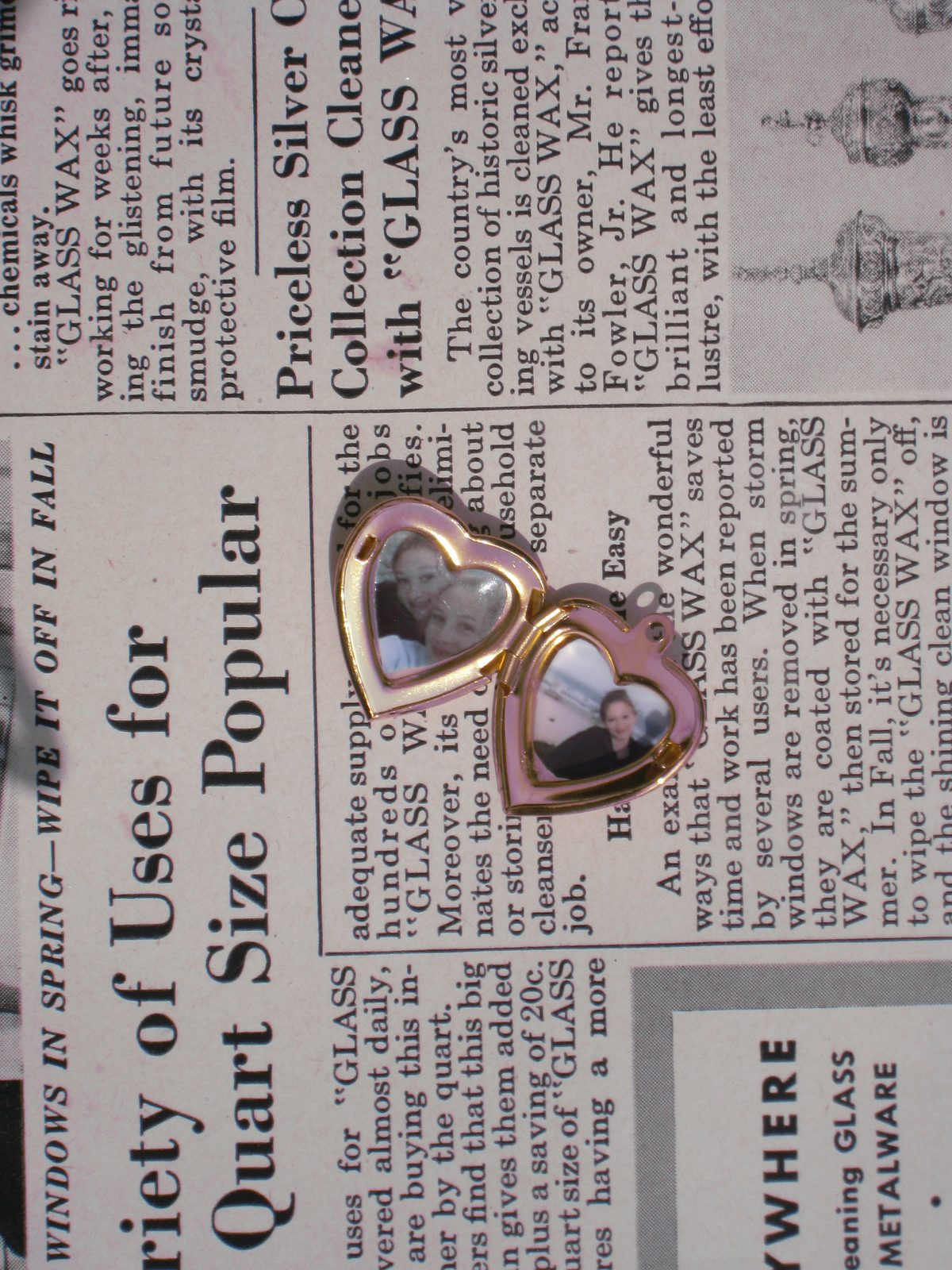 Open heart locket with two photos inside