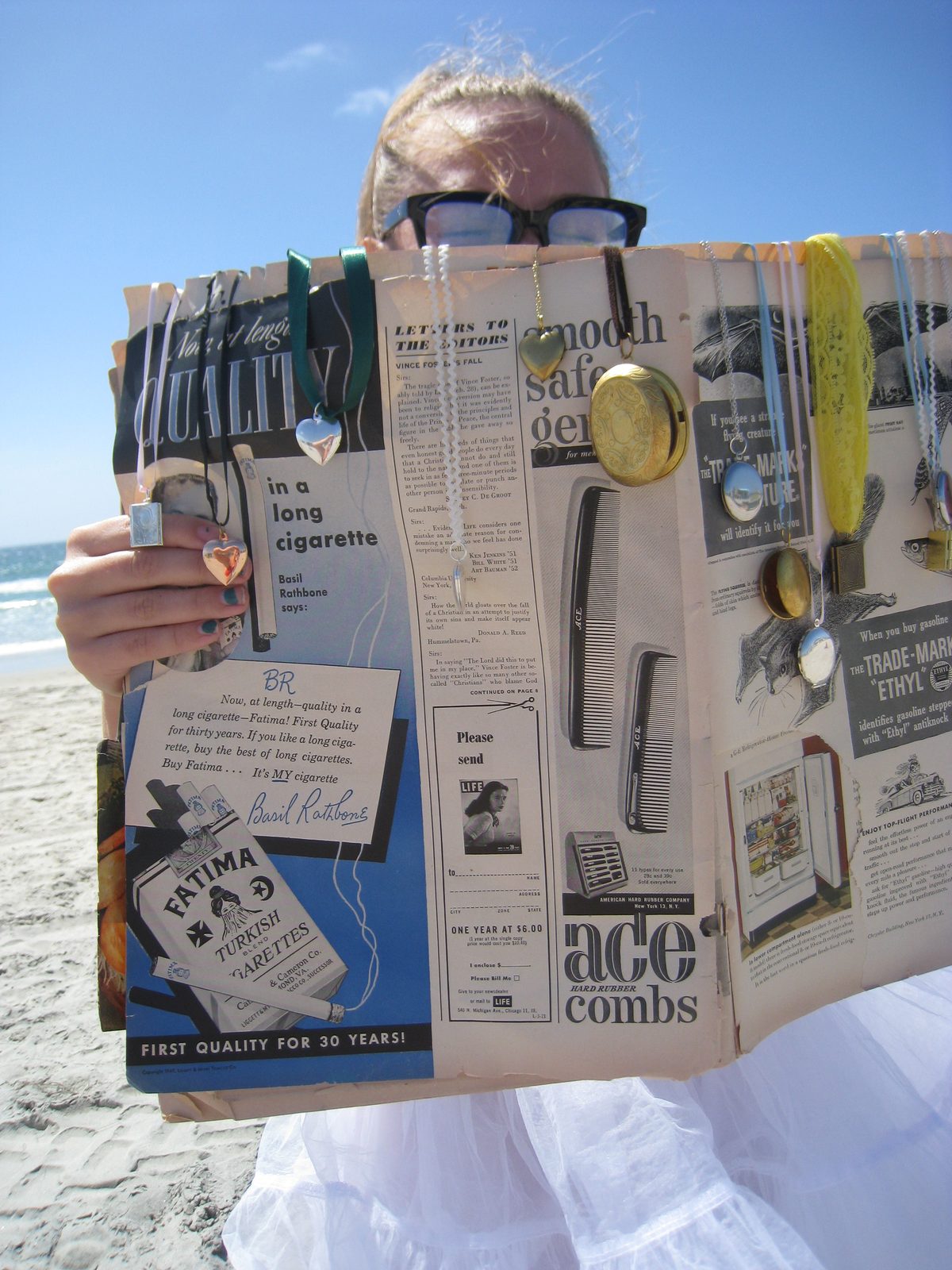 Reading on the beach with lockets clipped to the page