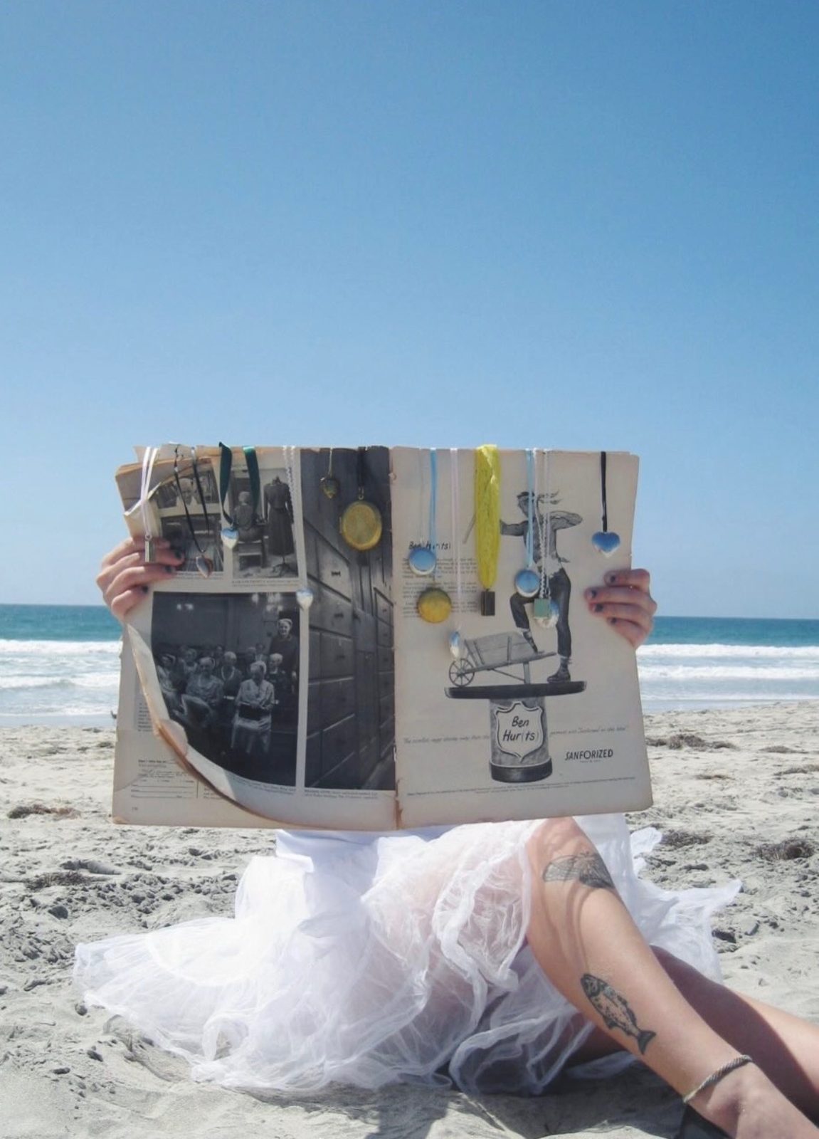 Beach day in a white dress with a scrapbook of lockets